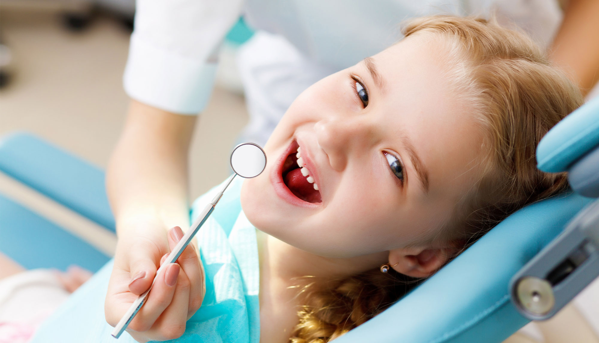 A child smiling during a gentle check-up at Westgate Family Dental